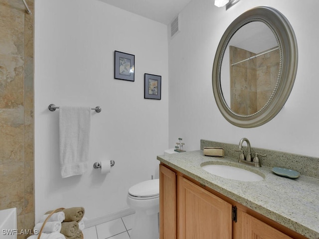 bathroom with toilet, a shower, vanity, and tile patterned floors