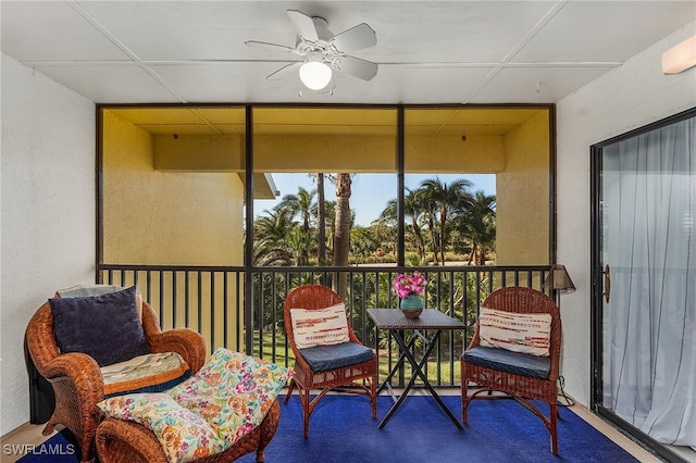 sunroom featuring ceiling fan