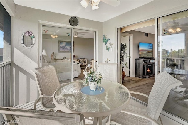 dining space with hardwood / wood-style flooring and ceiling fan