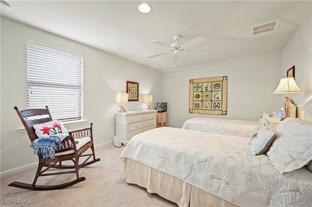 bedroom with ceiling fan and light colored carpet