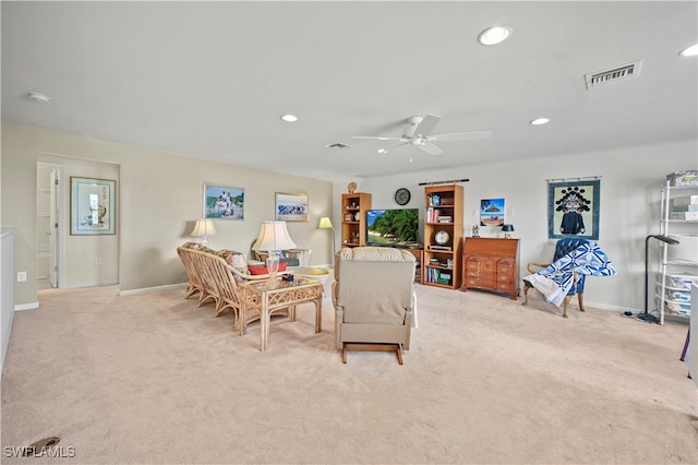 living room with light carpet and ceiling fan