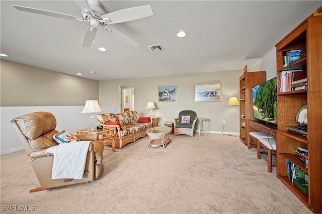 carpeted living room featuring ceiling fan