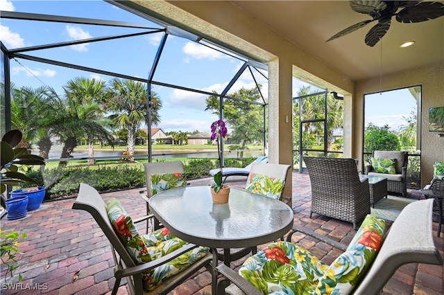 view of patio featuring an outdoor hangout area, glass enclosure, and ceiling fan