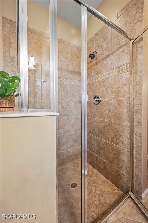 bathroom featuring tile patterned floors and a shower with shower door