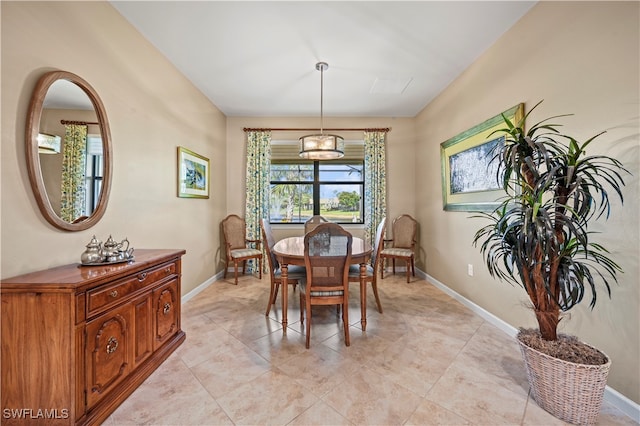 dining area with an inviting chandelier