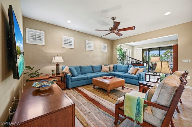 living room with light tile patterned floors and ceiling fan