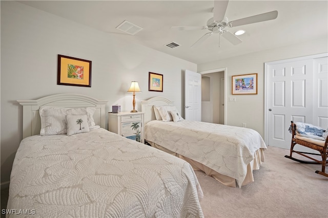 carpeted bedroom with ceiling fan and a closet