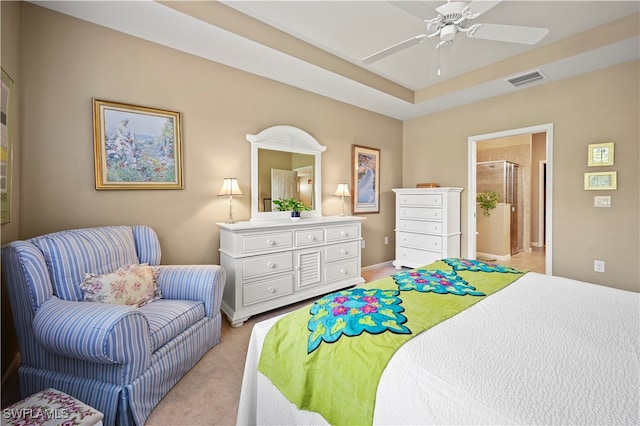 carpeted bedroom featuring ensuite bath and ceiling fan