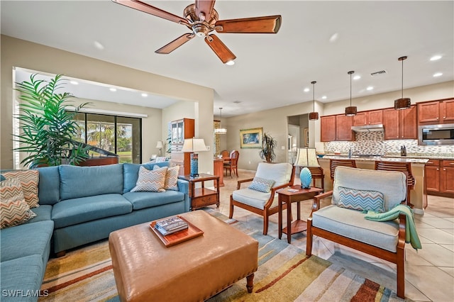 tiled living room with ceiling fan