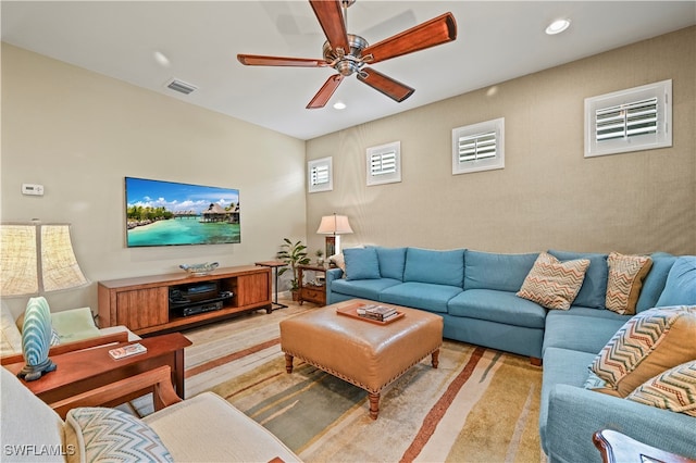 living room featuring ceiling fan and light carpet