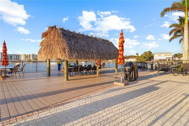 view of property's community with a gazebo and a water view