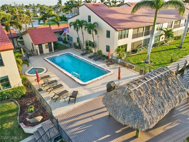 view of swimming pool with a patio area and a community hot tub