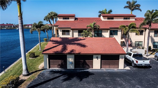 view of front of home with a water view and a garage