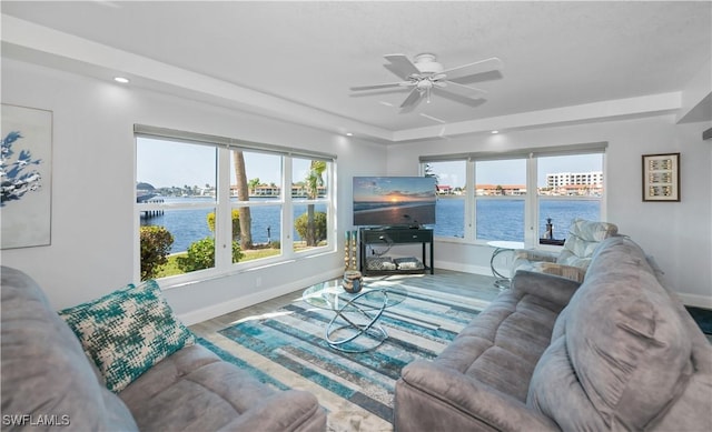 living room featuring ceiling fan and wood-type flooring