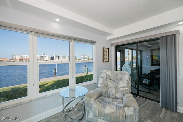 sunroom with plenty of natural light and a water view