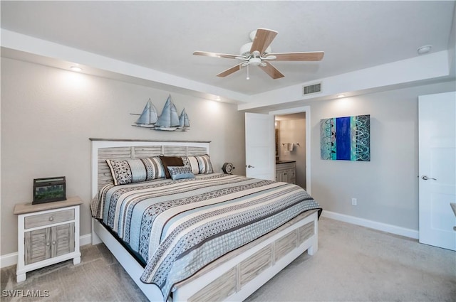 carpeted bedroom with ceiling fan and ensuite bathroom