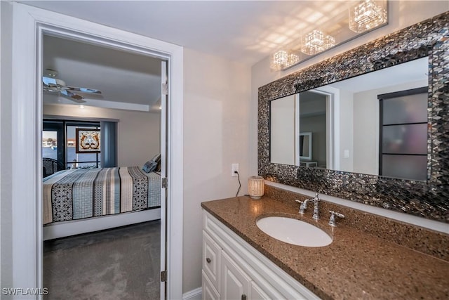 bathroom featuring vanity and ceiling fan with notable chandelier