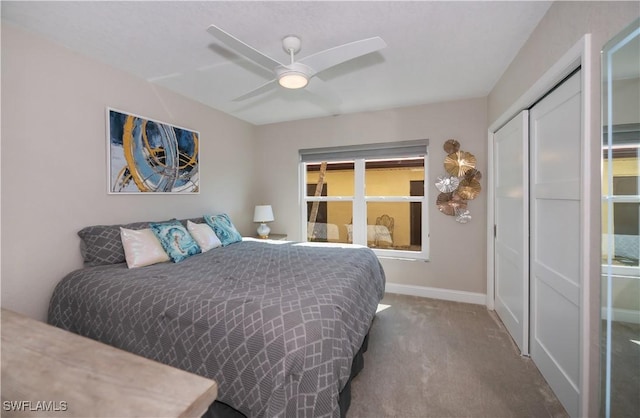 bedroom with ceiling fan, a closet, and carpet floors