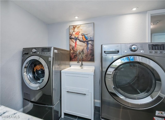 washroom featuring cabinets and independent washer and dryer