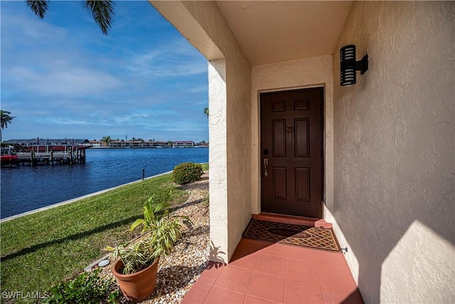 doorway to property with a water view