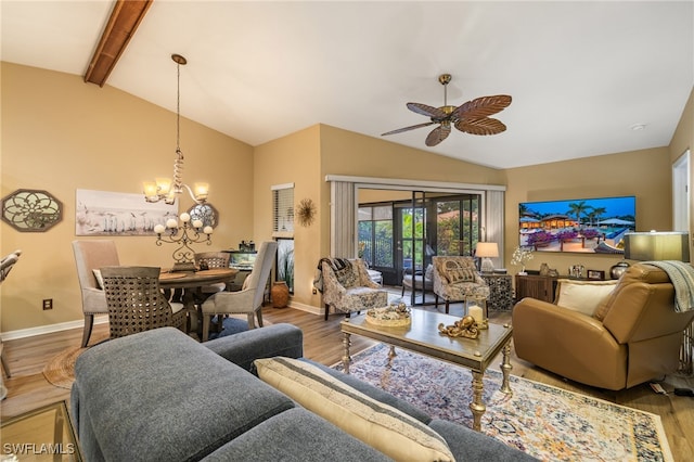 living room featuring lofted ceiling with beams, french doors, wood-type flooring, and ceiling fan with notable chandelier