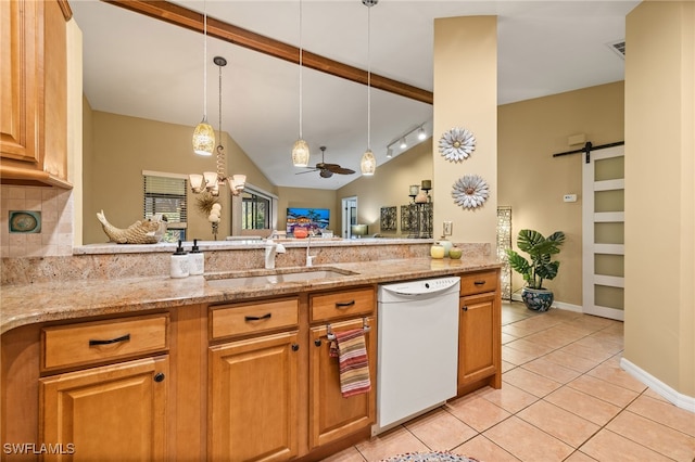 kitchen with white dishwasher, sink, ceiling fan, a barn door, and light stone counters