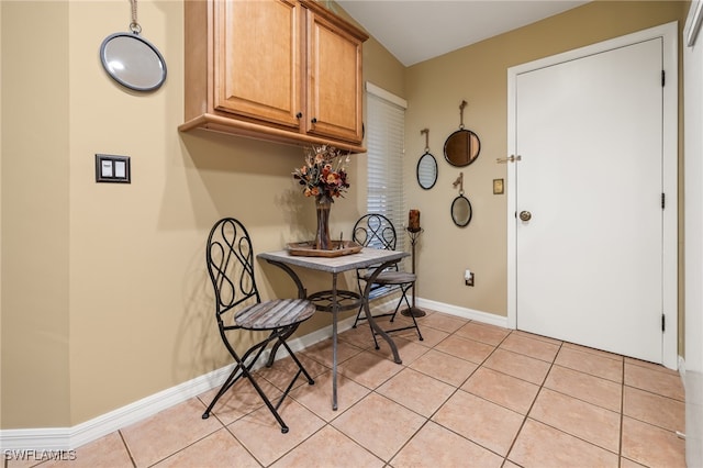 dining space featuring light tile patterned floors