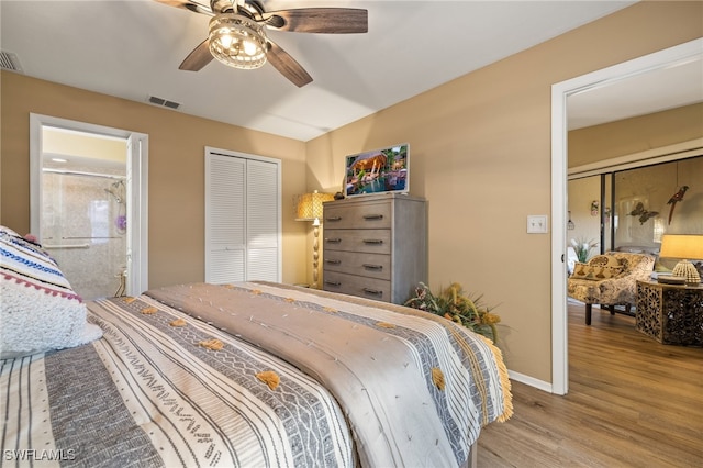 bedroom featuring hardwood / wood-style floors, ceiling fan, ensuite bath, and a closet