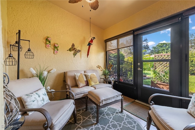 sunroom featuring lofted ceiling, ceiling fan, and a healthy amount of sunlight