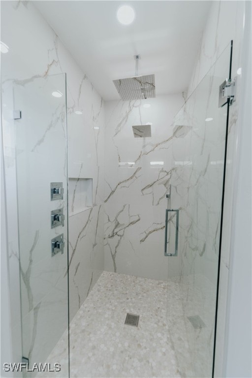 bathroom with a shower with shower door