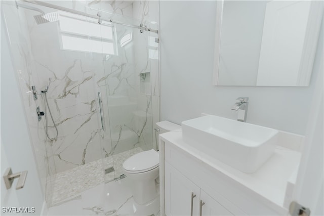 bathroom with toilet, an enclosed shower, and vanity