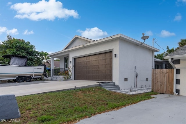 view of front of property with a garage and a front lawn