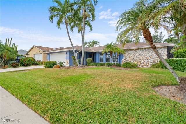 ranch-style house featuring a front yard and a garage