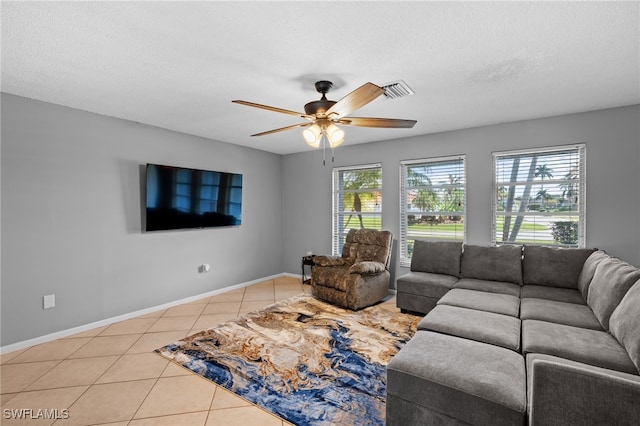 tiled living room featuring a textured ceiling and ceiling fan