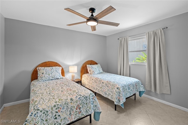 tiled bedroom featuring ceiling fan