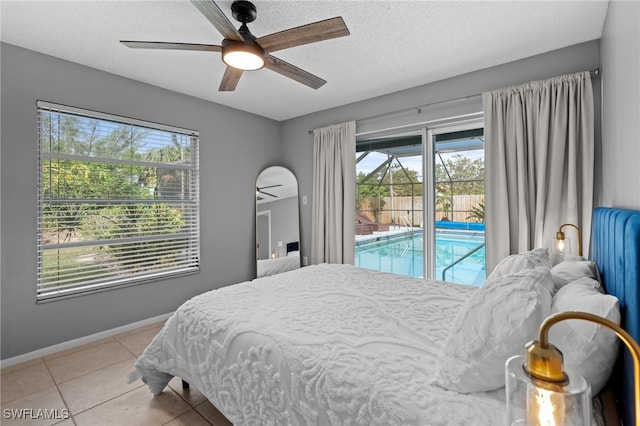 bedroom featuring access to exterior, light tile patterned floors, a textured ceiling, and ceiling fan