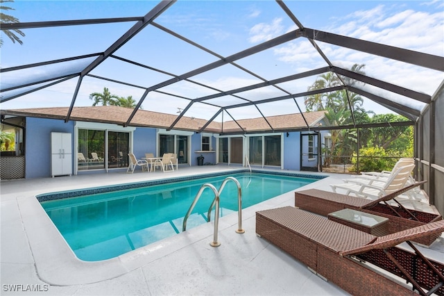 view of swimming pool with a patio and a lanai