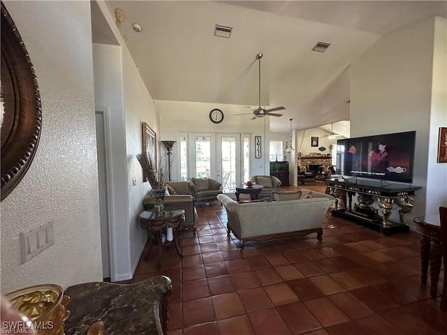 living room featuring dark tile patterned flooring, ceiling fan, high vaulted ceiling, and french doors