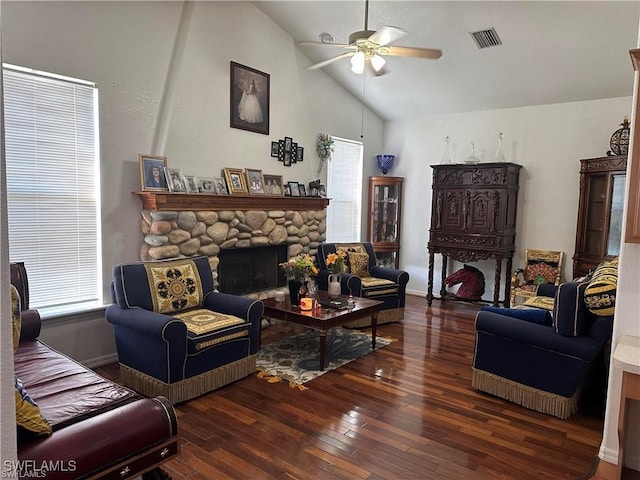 living room featuring a stone fireplace, ceiling fan, high vaulted ceiling, and dark wood-type flooring