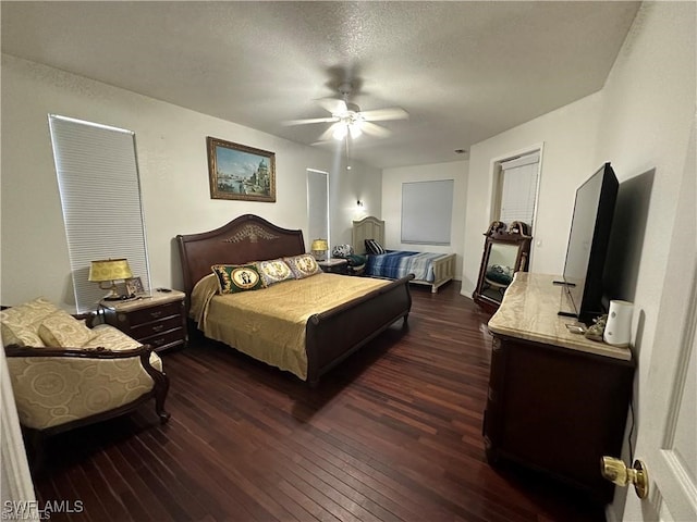 bedroom featuring a textured ceiling, dark hardwood / wood-style flooring, and ceiling fan