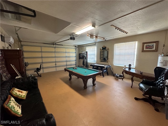 playroom with water heater, concrete floors, a textured ceiling, and billiards