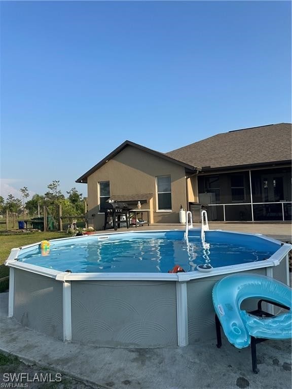 view of swimming pool with a sunroom