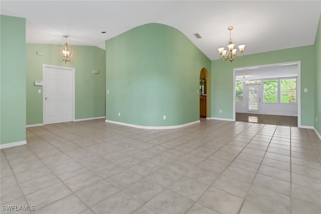 unfurnished room with light tile patterned floors, vaulted ceiling, and a notable chandelier