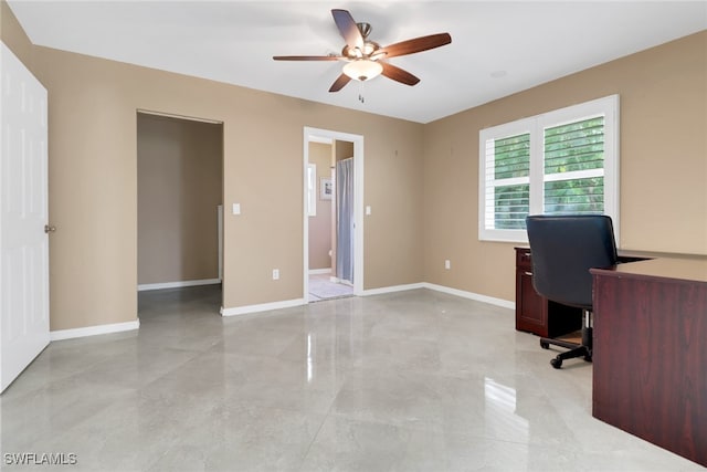 unfurnished office featuring ceiling fan