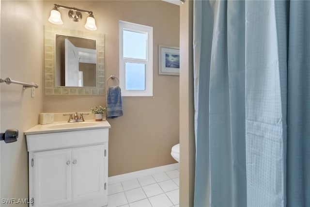 bathroom featuring tile patterned flooring, vanity, and toilet