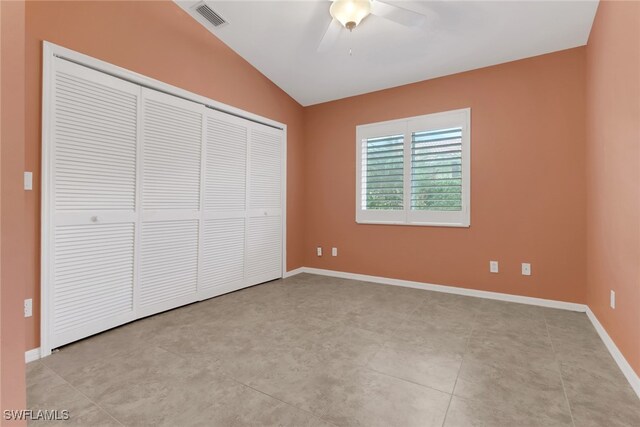 unfurnished bedroom with a closet, ceiling fan, and lofted ceiling