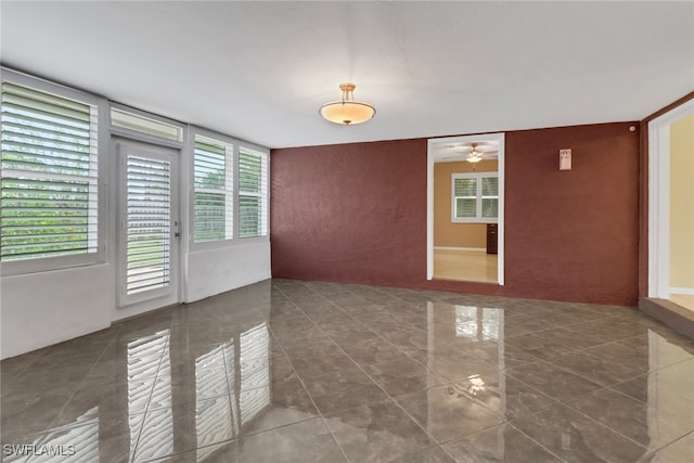 tiled empty room with ceiling fan