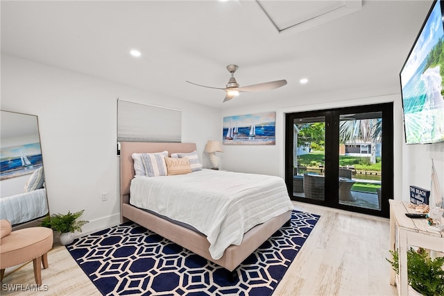 bedroom with access to exterior, recessed lighting, attic access, and wood finished floors