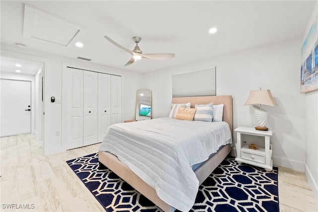 bedroom featuring recessed lighting, a closet, attic access, wood finished floors, and baseboards