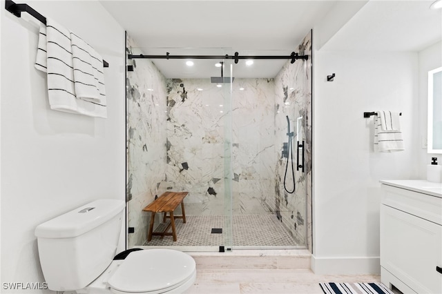 bathroom with vanity, a marble finish shower, toilet, and baseboards